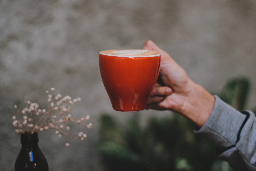 Photo of Hand Holding Red Cup of Coffee