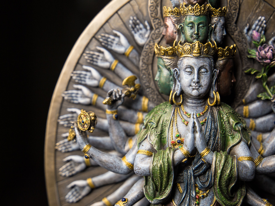 Avalokitesvara Eleven Faced statue on black surface